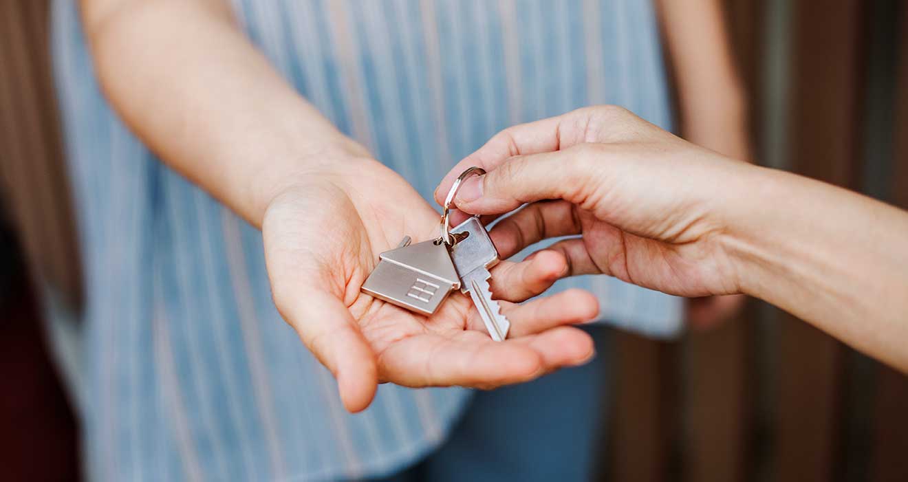 Keys to a new home being placed in someones hand. 