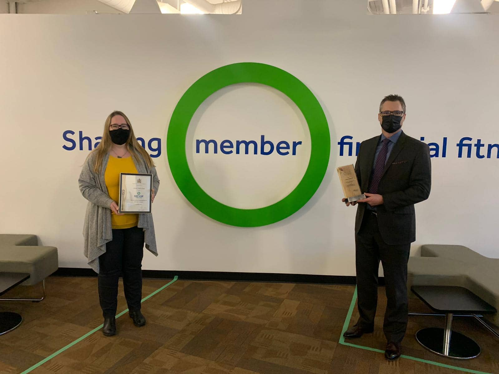 A photo of Servus Chief Operating Officer, Dion Linke, accepts 2020 Minister's Seniors Service Award from Edmonton-Mill Woods MLA Christina Gray.