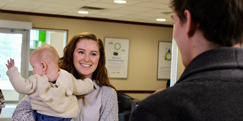 Hannah with her youngest daughter, at the Servus teller counter